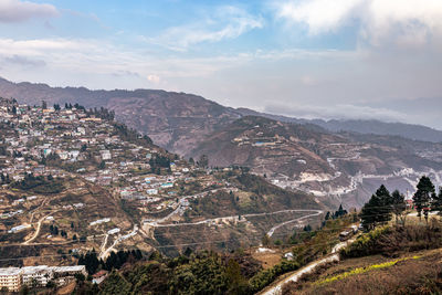 City urbanization view from hilltop with huge construction and dramatic sky