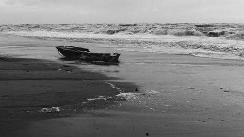 Boat on beach against sky