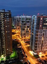 High angle view of illuminated buildings against sky at night