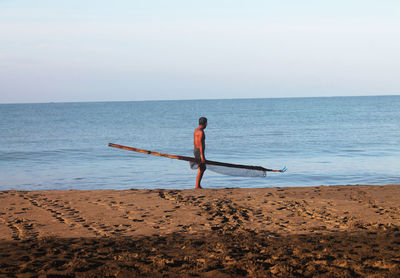 Full length of man on beach against sky
