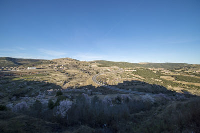 Scenic view of mountains against clear blue sky