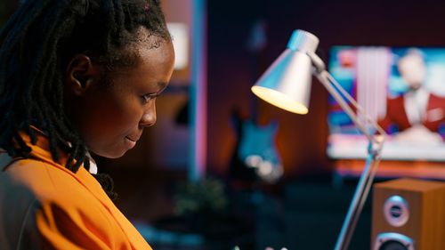 Side view of young woman using mobile phone