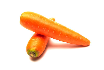 Close-up of orange fruit against white background