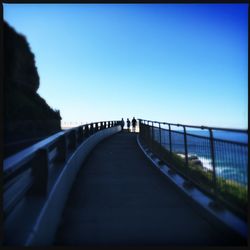 Bridge over river against blue sky