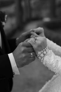 Midsection of couple holding hands