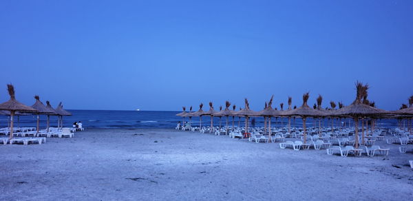 Panoramic view of beach against clear blue sky