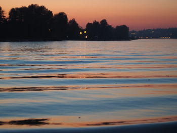 Scenic view of lake against romantic sky at sunset