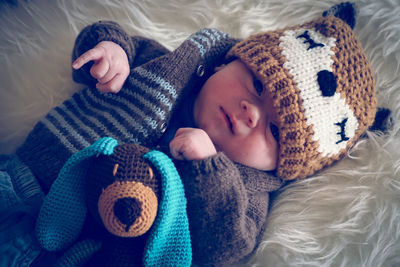 Close-up of baby boy lying on bed