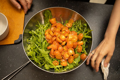 Close-up of person preparing food in pan