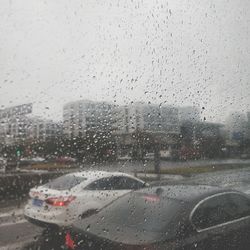 Close-up of wet car window in rainy season