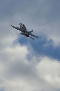 Low angle view of airplane flying against sky