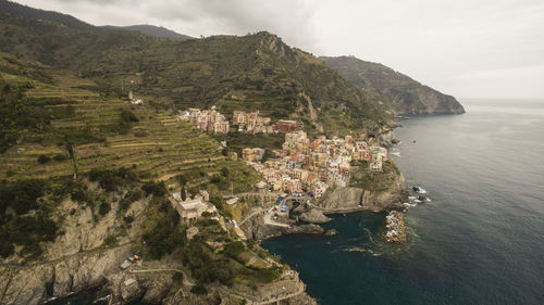 High angle view of townscape by sea against sky