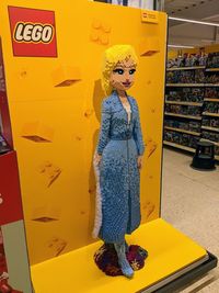 Full length of woman with toy standing at store