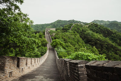 Great wall of china by trees against sky