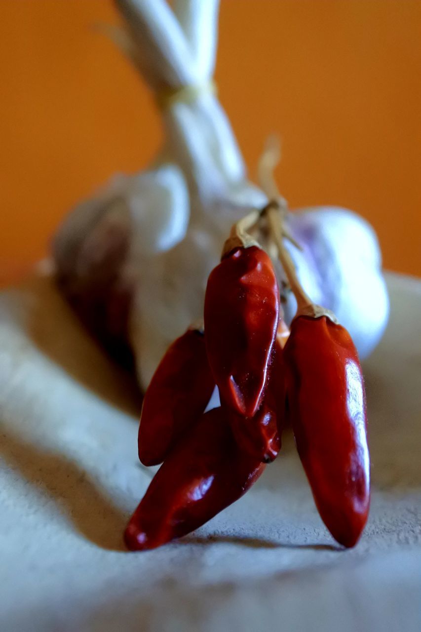 CLOSE-UP OF RED CHILI PEPPERS ON TABLE