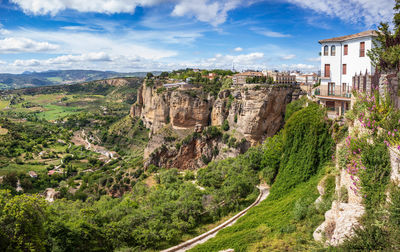 Panoramic view of trees and buildings against sky