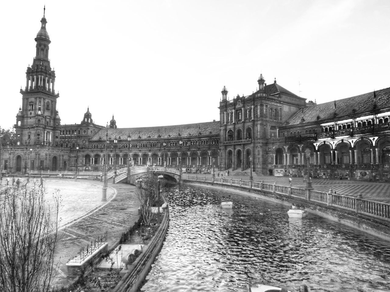 VIEW OF BRIDGE OVER RIVER IN CITY AGAINST SKY