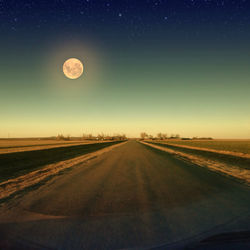 Scenic view of road against clear sky at night