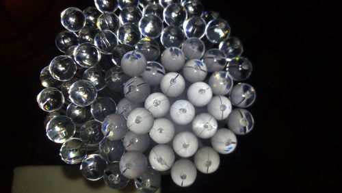 Close-up of illuminated lighting equipment on black background