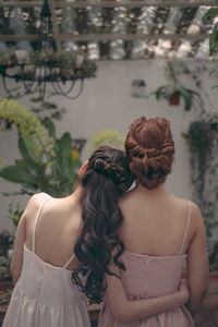 Rear view of women in back yard