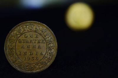 Close-up of coins over white background