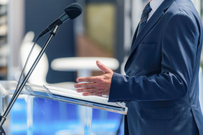 Midsection of businessman using mobile phone