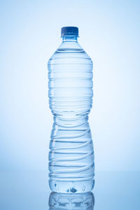 Close-up of water bottle against blue background