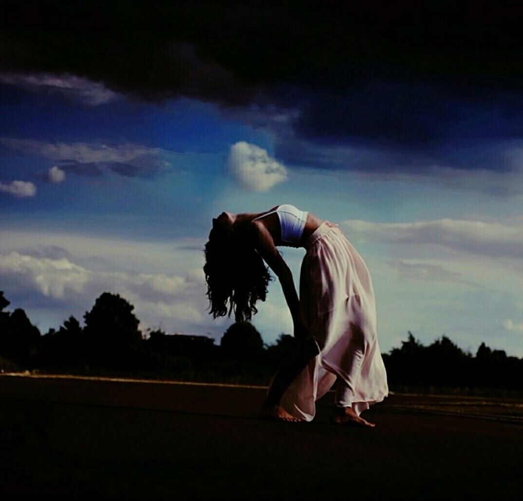 sky, field, silhouette, one person, cloud - sky, cloud, full length, nature, rear view, outdoors, landscape, beauty in nature, tree, dusk, tranquility, sunlight, sunset, side view, tranquil scene, day