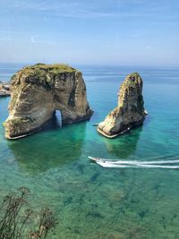 Panoramic view of rock formation in sea against sky