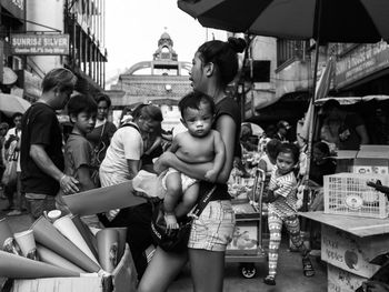 People at market stall in city