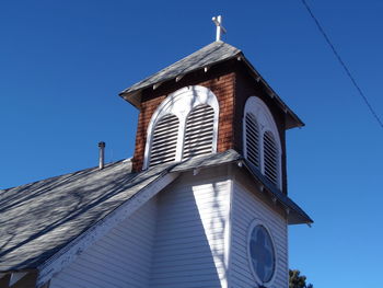 Low angle view of built structure against clear blue sky