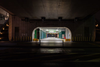 Illuminated railroad station platform at night