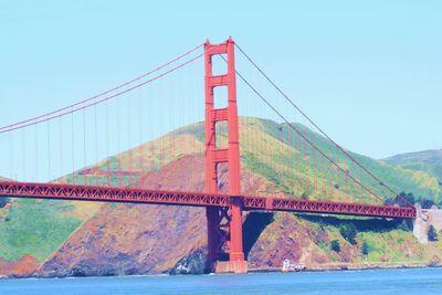 Golden gate bridge over river against sky