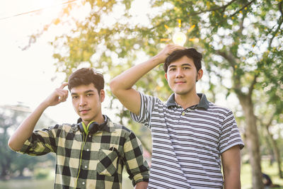 Portrait of young men standing in park