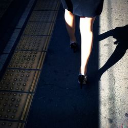 Low section of people walking on road