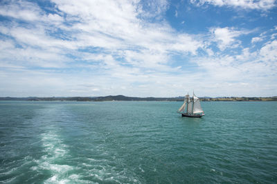 Sailboat sailing on sea against sky