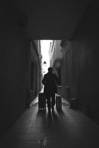 Rear view of people walking in tunnel