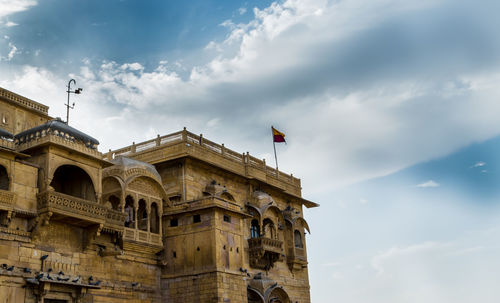 Low angle view of historical building against cloudy sky