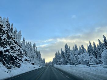 Panoramic view of snow covered mountains against sky