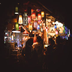 Group of people in illuminated building at night