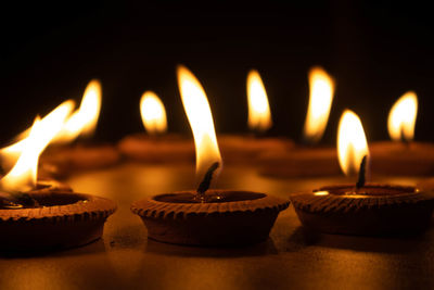 Close-up of illuminated candles on table