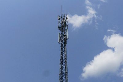 Low angle view of communications tower against sky