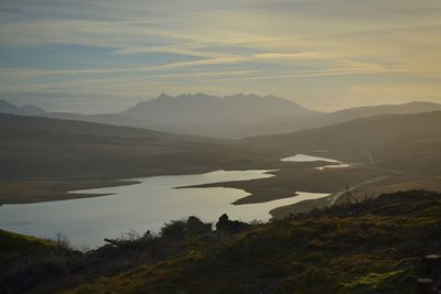 Scenic view of river and mountains against sky