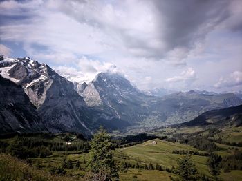 Scenic view of eiger mountain against cloudy sky