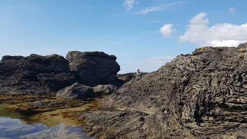 Rock formation on land against sky