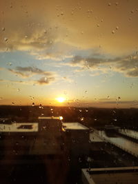 Full frame shot of wet car window during sunset