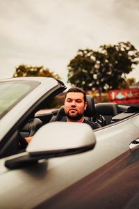 Portrait of man sitting in car