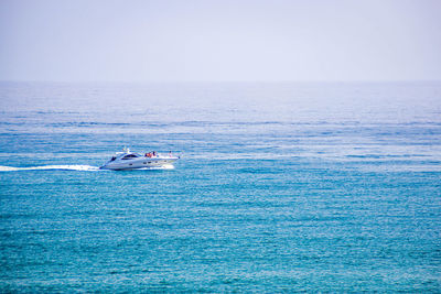 Boat sailing in sea against sky