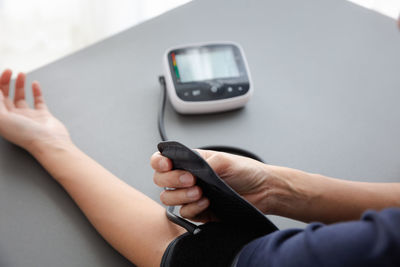 Midsection of man using mobile phone