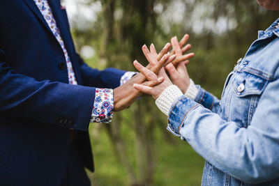 Midsection of couple holding hands